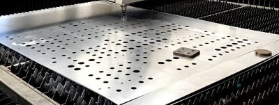 Perforated stainless steel sheet on the laser cutting bed — Custom Perforation Patterns · Perforated & Mesh