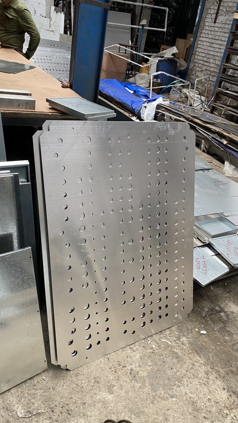 Perforated stainless steel façade panel with a hexagonal cut pattern