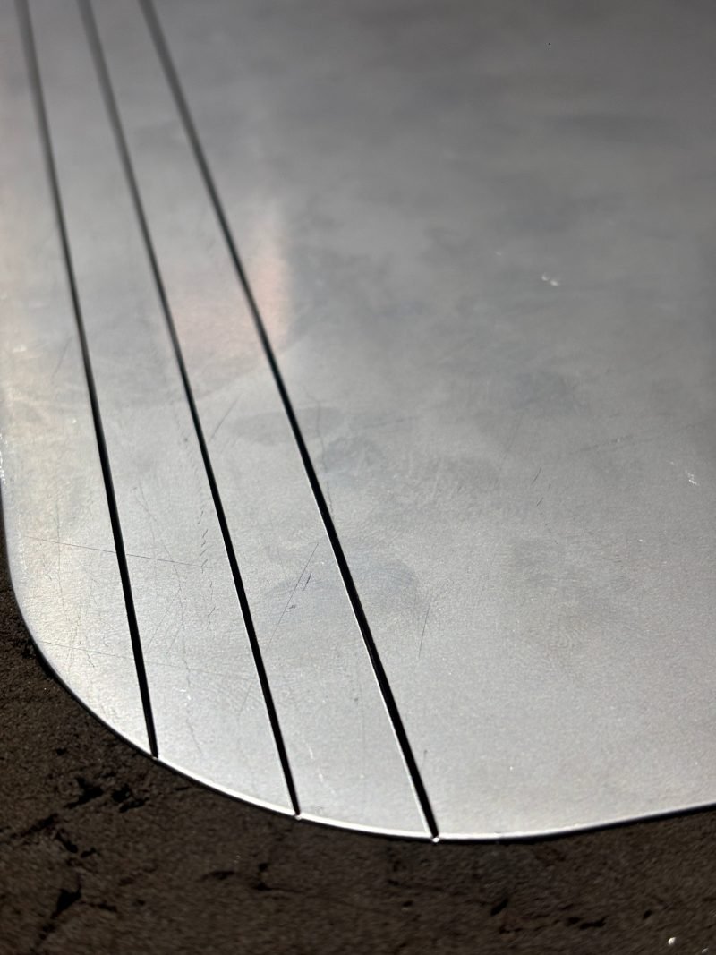 A curved blank with three V-grooves before forming