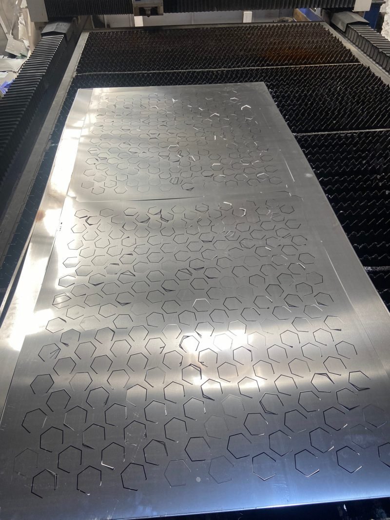 Hexagonal perforation being cut on the laser bed