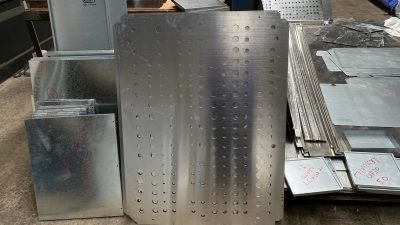 Perforated facade panels stacked after folding — Perforated Façade Panels · Façade Systems
