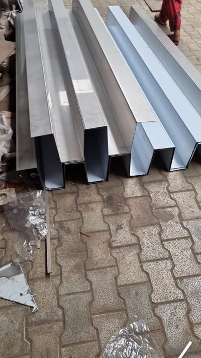 Folded stainless steel profiles stacked after bending — Stainless Steel Fabrication · Custom Fabrication