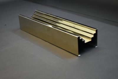 A fluted wall highlighter profile in gold PVD — Wall & Tile Highlighter Strips · Architectural Profiles
