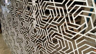 A laser-cut geometric pattern screen, close up