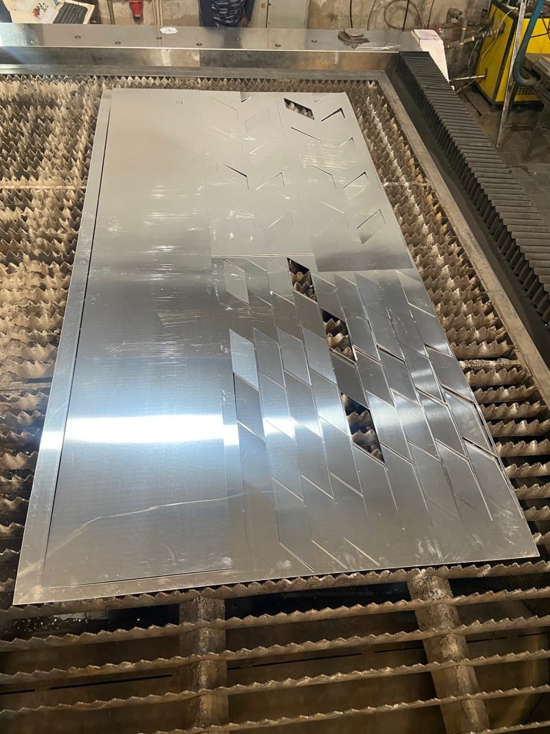 Laser-cut blanks on the bed with their cut-outs