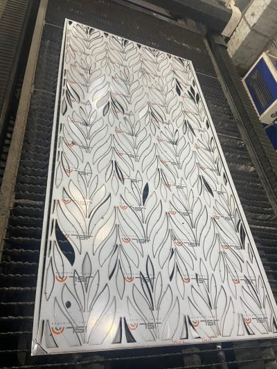 A leaf pattern screen panel on the laser bed — Decorative Space Dividers · Partitions