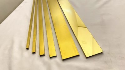 U channels in gold PVD laid flat, widths side by side — U & C Profile · Architectural Profiles